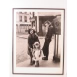Photographic print; three children posing on French street, framed and glazed, overall 73.5 x 28cm.