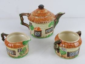 A Beswick tea service pattern 240, 245 and 246 in the form of cottages.