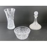 A large crystal glass vase in original box, together with a cut glass decanter and fruit bowl.