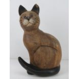 A carved and painted wooden figurine of a cat, one ear slightly a/f, 28cm high.