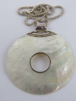 A large silver and mother of pearl disc pendant, 7.