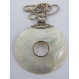 A large silver and mother of pearl disc pendant, 7.