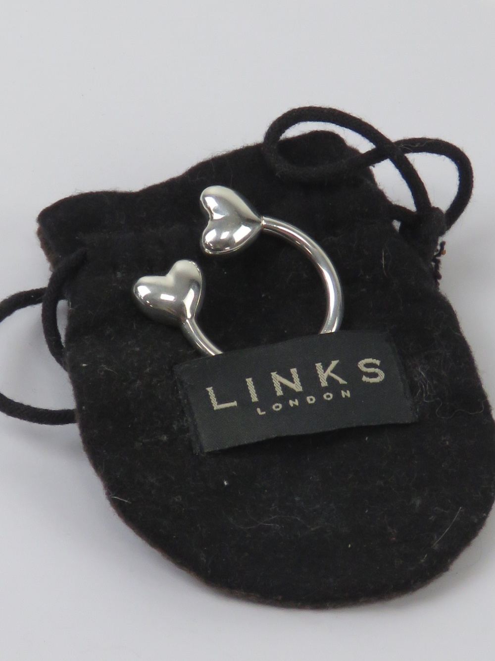 Links of London; a HM silver key chain with heart terminals,