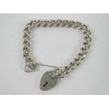 A heavy HM silver charm bracelet having heart padlock clasp, clasp stamped silver,