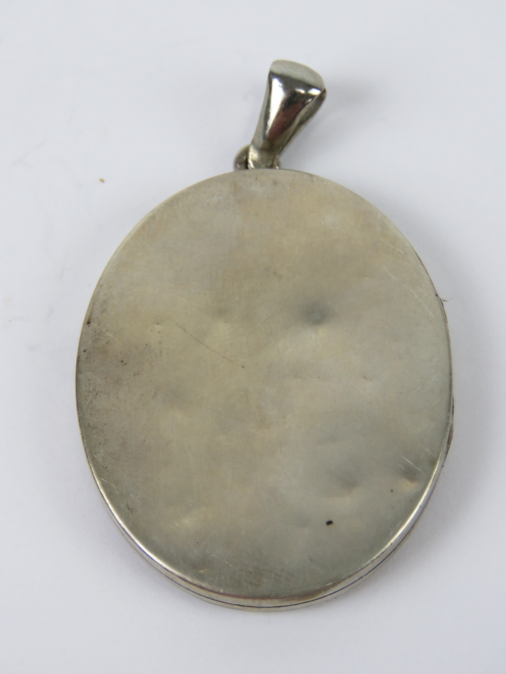 A large vintage white metal locket having BCH monogram to centre of leafy wreath, 5.4cm in length. - Image 3 of 3