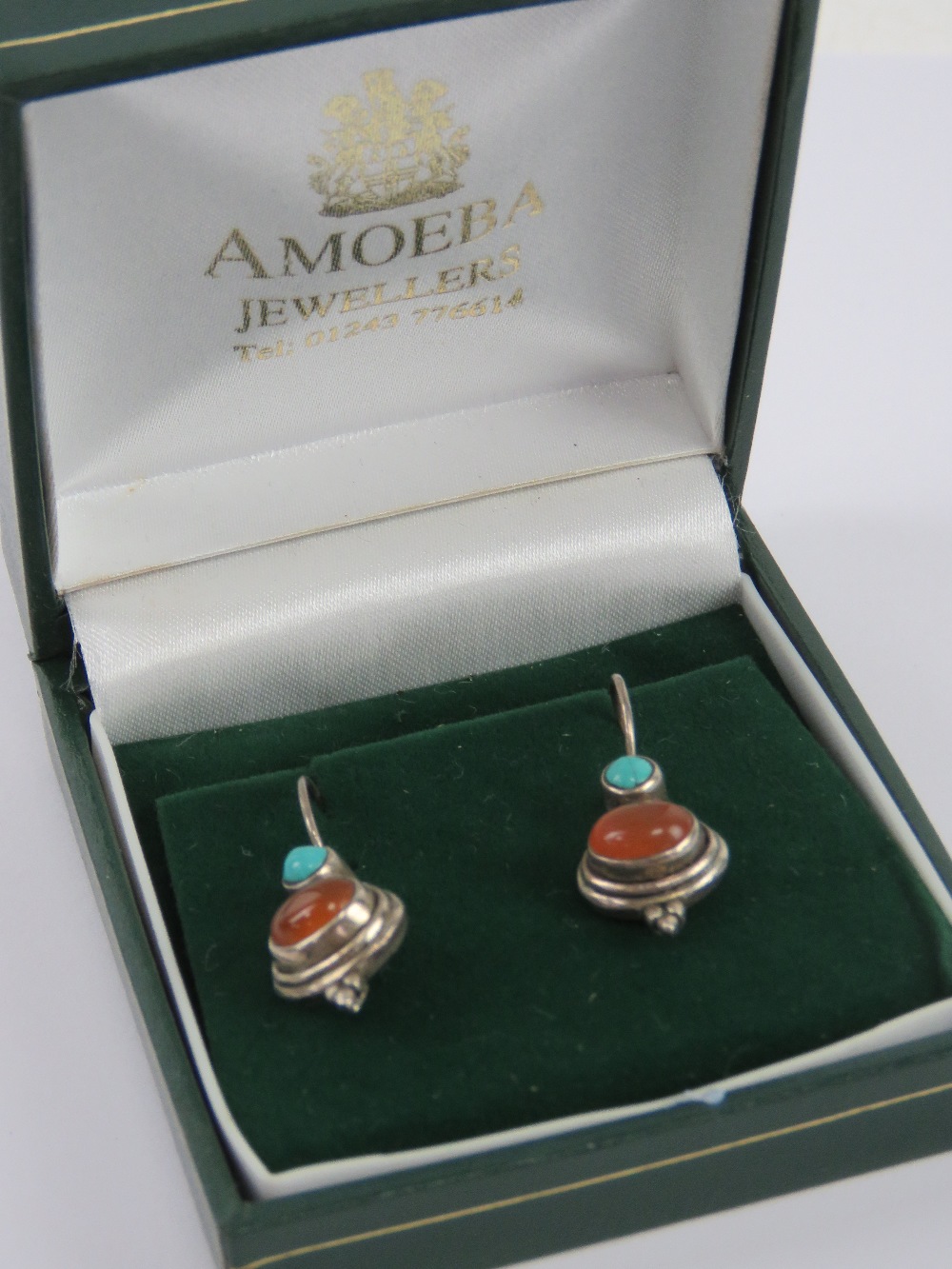 A pair of silver Native American style carnelian and turquoise earrings, stamped 925, 3cm drop.