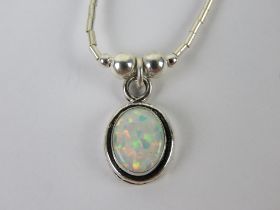 A 925 silver and opal pendant of oval form on a Native American style beaded chain.