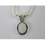 A 925 silver and opal pendant of oval form on a Native American style beaded chain.