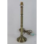 A single brass column table lamp.