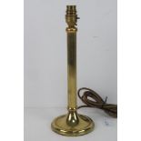 A single brass column style table lamp.