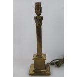 A single brass column table lamp.