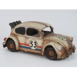 A contemporary metal model of a VW beetle No53 with racing stripes.