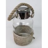 A contemporary 'storm lantern' having rope design on glass jar, solar panel untested,