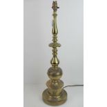 A large and heavy brass table lamp of column form.