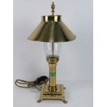 A single brass table lamp having glass chimney and brass shade bearing label 'Orient Express Paris