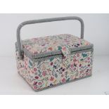 A sewing box covered in floral patterned fabric