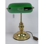 A brass 'bankers' lamp with green glass shade.