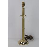 A single brass column table lamp.