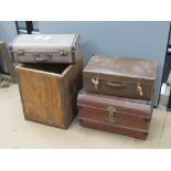 A metal trunk, two vintage suitcases and a vintage tea crate. Four items.