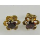 A pair of 9ct gold and garnet floral earrings, hallmarked 375, with butterfly backs, 1.7g.