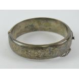 A HM silver hinged bangle having floral engraved decoration, hallmarked for chester, 6.2 x 5.