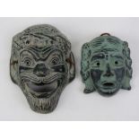 Two terracotta Greek theatre masks, largest 13.3cm in length.