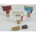 Three vintage ceramic and cork bottle stoppers together with a contemporary bottle stopper having