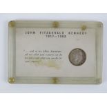 A John Fitzgerald Kennedy (JFK) 1917-1963 commemorative 1964 half dollar coin in plastic pod.