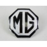 A vintage enamel MG car badge.