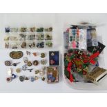 A quantity of costume jewellery, pin badges and jewellery fixing items.