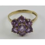 A 9ct gold and amethyst large floral cluster cocktail ring, hallmarked 375, size P, 3.15g.