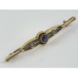 A 9ct gold amethyst and seed pearl bar brooch, stamped 9ct, 5.4cm wide, 1.7g.