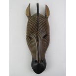 A carved wood and handpainted decorative wall mask in the form of a Zebra, approx 38cm in length.