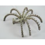 A large contemporary brooch in the form of a spider set with white stones, approx 7cm wide.