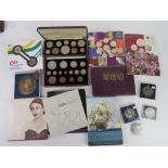 A quantity of commemorative coins and proof coin sets.