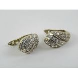 A pair of 14ct gold earrings set with white stones, stamped 585, 4.23g.