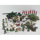 A quantity of Britains model toys including metal military artillery items and horse,