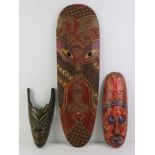 Three contemporary hand painted decorative wall masks,