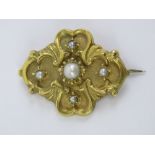 A Victorian yellow metal brooch set with split pearl and seed pearls, 3.3cm wide, 3.7g.