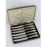 A set of HM silver handled butter knives in original fitted case, steel blades marked for Viners.