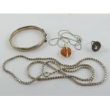A silver and Baltic amber pendant on chain, together with a HM silver hinged bangle,