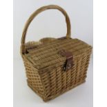 A wicker picnic basket / hamper having twin bottle holders and loop handle over, 32cm wide.