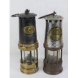Two decorative Miners lamps 'Patterson Lamps Ltd' and 'Protector Lamp & Lighting Co Ltd Eccles',