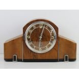 An Art Deco walnut and bakelite mantle clock.