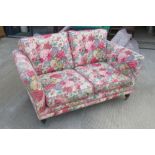 A chintz floral two seater settee 154 x 92cm.