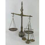 Two pairs of Victorian brass balance scales with weights.