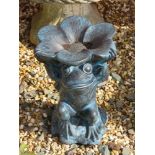 A resin frog garden ornament holding flower overhead, 30cm high.