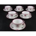 A set of six Richard Ginori cups and saucers in white ground with pink rose pattern upon.
