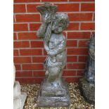 A pre-cast base for a birdbath or table in the form of a child carrying a cornucopia,