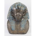 A large plaster bust of an Egyptian Pharaoh painted in blues and gold, 32cm high.